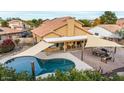 Aerial shot of a backyard featuring a pool and sail shades at 7365 W Via Del Sol Dr, Glendale, AZ 85310