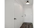 Hallway with clean white walls and multiple storage closets at 815 N Hayden Rd # B109, Scottsdale, AZ 85257