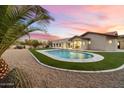 Backyard with an artificial turf surround, a sparkling pool and desert landscaping at 8254 E Juan Tabo Rd, Scottsdale, AZ 85255