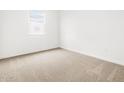 Neutral-toned carpeted bedroom featuring a bright window at 8555 W Trenton Ct, Florence, AZ 85132