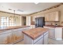 Open kitchen showcasing tile countertops, modern appliances, and a large island at 9372 E Aster Dr, Scottsdale, AZ 85260