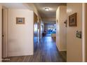 Interior view of hallway with wood style floors and views of the living room at 100 N Vulture Mine Rd # 103, Wickenburg, AZ 85390