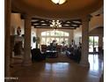 Elegant living room with tall pillars, coffered ceiling, stone fireplace, and lots of natural light at 1367 S Country Club Dr # 1315, Mesa, AZ 85210