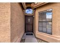 Inviting front entry features a decorative door with a transom window and a 'hello' doormat at 16808 N 59Th Pl, Scottsdale, AZ 85254