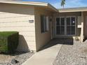 The exterior of this home features desert landscaping, light-colored siding, and a cozy front entrance at 17019 N Pinion Ln, Sun City, AZ 85373