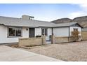 Well-kept single-story home featuring a secure gated yard and desert landscaping, offering curb appeal and security at 1730 W Pershing Ave, Phoenix, AZ 85029