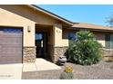 Inviting front entrance featuring stone accents, desert landscaping, and a covered entryway for curb appeal at 1920 E Manzanita Dr, Phoenix, AZ 85020