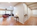 Spacious living room with tile flooring, a ceiling fan, and lots of natural light at 19217 N Casa Blanca Way, Surprise, AZ 85387