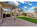 Back patio of this home features a covered area and lush green grass at 1998 S Starling Dr, Gilbert, AZ 85295