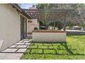 Enchanting outdoor patio with a custom-built pergola and charming fireplace, perfect for relaxing and entertaining at 2007 S El Camino Dr, Tempe, AZ 85282