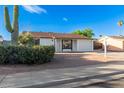 Cozy single-story home with desert landscaping, attached garage, and covered parking at 2336 W Plata Ave, Mesa, AZ 85202