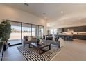 Bright living room with a sliding glass door, modern furniture, and a view of the open floor plan at 24066 S 218Th Pl, Queen Creek, AZ 85142