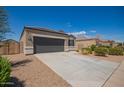 Charming single-story home with a well-manicured front yard, two car garage, and neutral colored stucco at 2420 E San Borja Trl, Casa Grande, AZ 85194