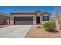 Charming single-story home with a well-manicured front yard, two car garage, and neutral colored stucco at 2420 E San Borja Trl, Casa Grande, AZ 85194