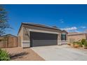 Charming single-story home with a well-manicured front yard, two car garage, and neutral colored stucco at 2420 E San Borja Trl, Casa Grande, AZ 85194