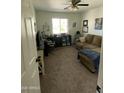 Versatile bedroom featuring a comfortable couch, desk, and natural light, perfect for a home office at 266 S Eliseo Felix Jr Way, Avondale, AZ 85323