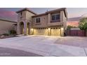 Beautiful home featuring a stone arch entryway, three-car garage, and well-maintained landscaping at 27406 N 22Nd Ln, Phoenix, AZ 85085