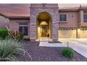 Charming home featuring a stone arch entry way, manicured yard, and a warm, inviting ambiance at 27406 N 22Nd Ln, Phoenix, AZ 85085