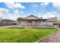 Expansive backyard featuring covered patio, lush lawn, and outdoor seating area at 2747 S Brooks --, Mesa, AZ 85202