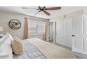 Relaxing bedroom with a ceiling fan, plantation shutters, and a closet with sliding doors at 2747 S Brooks --, Mesa, AZ 85202