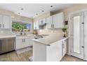 Bright kitchen featuring white cabinets, stainless steel appliances, quartz countertops, and an eat-in island at 2747 S Brooks --, Mesa, AZ 85202