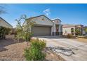 This single-Gathering home boasts a two-car garage, appealing low maintenance landscaping, and a private driveway at 30747 W Indianola Ave, Buckeye, AZ 85396