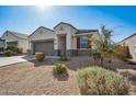 A well-maintained single-Gathering home exhibits appealing low maintenance landscaping and a two-car garage at 30747 W Indianola Ave, Buckeye, AZ 85396