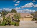 Charming single-story home with a well-manicured front yard, three car garage, and inviting curb appeal at 3546 E Latham Way, Gilbert, AZ 85297