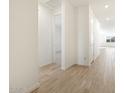 Bright hallway with wood-look tile flooring leading to bedrooms and living areas at 3764 N Camden Dr, Florence, AZ 85132