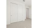 Bedroom featuring neutral carpet and double doors, leading to another room at 3782 N Camden Dr, Florence, AZ 85132