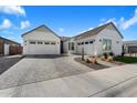 Attractive home with three-car garage, landscaped front yard with decorative rock, pavers, and drought-resistant plants at 4097 E Tonto Pl, Chandler, AZ 85249