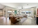 Bright and airy living room featuring a comfortable sectional, leather chair, and large sliding glass doors to the patio at 4097 E Tonto Pl, Chandler, AZ 85249