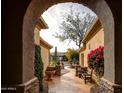 Beautiful courtyard with stone accents, lush greenery, and serene desert views at 41413 N Club Pointe Dr, Anthem, AZ 85086