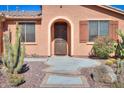 Welcoming home with arched entryway and desert landscaping at 42432 W North Star Dr, Maricopa, AZ 85138