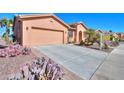 Inviting home featuring desert landscaping and a spacious driveway leading to a two-car garage at 42432 W North Star Dr, Maricopa, AZ 85138