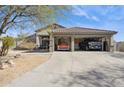 Spacious three car garage featuring a covered carport and ample parking for multiple vehicles at 4665 S Palacio Way, Gold Canyon, AZ 85118