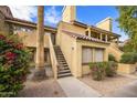 Charming condo with red tile roof, private entry stairs, desert landscaping, and bright flowering bushes at 4901 S Calle Los Cerros Dr # 264, Tempe, AZ 85282