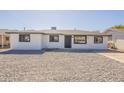 Single-story home showcasing a modern design and xeriscaped front yard for easy upkeep at 5731 W Morten Ave, Glendale, AZ 85301