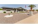 Welcoming house featuring minimalist desert landscaping, complemented by solar panels at 6456 E Dallas St, Mesa, AZ 85205