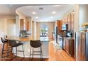 Well-equipped kitchen featuring granite counters, wood floors, and stainless appliances at 6795 S Sapphire Way, Chandler, AZ 85249