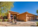 Inviting single story home with a desert landscape and a convenient three-car garage at 7138 W Buckskin Trl, Peoria, AZ 85383