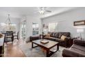 Cozy living room with hardwood floors, neutral tones, and a ceiling fan, creating a warm atmosphere at 7401 W Arrowhead Clubhouse Dr # 2079, Glendale, AZ 85308