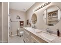 Bright bathroom with dual sinks, marble countertops, and modern fixtures at 8230 E Valley Vista Dr, Scottsdale, AZ 85250