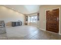 Welcoming entryway with tile flooring, a wooden door, and neutral wall colors at 8984 E Sutton Dr, Scottsdale, AZ 85260