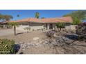 Inviting single-story home featuring desert landscaping, a tile roof, and a welcoming front entrance at 8984 E Sutton Dr, Scottsdale, AZ 85260