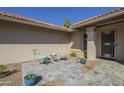 Cozy front porch area with seating, potted plants, and decorative stone flooring at 8984 E Sutton Dr, Scottsdale, AZ 85260