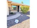 Inviting walkway leading to front door, accented by desert landscaping and decorative rocks at 904 Leisure World --, Mesa, AZ 85206