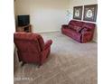 Cozy living room with plush carpeting and comfortable seating, perfect for relaxation at 904 Leisure World --, Mesa, AZ 85206