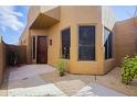 Beautiful stucco home with a dark wood door, desert landscaping and gravel at 9576 E Kiisa Dr, Scottsdale, AZ 85262