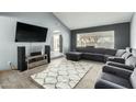 Spacious living room with vaulted ceiling, tile flooring and gray sectional sofa at 10008 N 50Th Dr, Glendale, AZ 85302